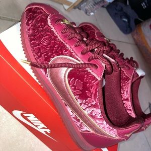 Red velvet Nike Cortez sneakers.